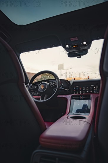 Modern car interior with steering wheel and advanced cockpit, Porsche Taycan, Deer car sharing.
