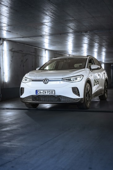 White electric car in an illuminated tunnel with a modern, urban feel, VW ID4 electric car, Deer