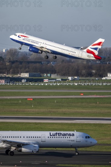 Lufthansa Airbus A321-200 on taxiway for takeoff, British Airways Airbus A320-200 on takeoff,