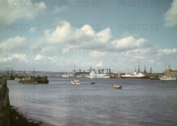 Aircraft carrier HMS Ark Royal (R09) or her sister ship HMS Eagle (R05), with Royal Yacht