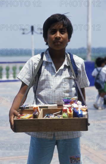 Boy with belly shop selling sweets in Iquitos, Amazon basin, Peru, South America, September 1997,