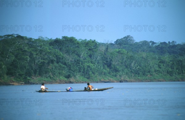 Boat traffic on the Rio Tambopata near Puerto Maldonado in the Amazon Basin, Peru, South America,