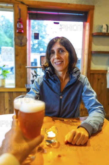 Tourist enjoying a refreshing craft beer in a cozy pub in ucluelet, a charming town on vancouver
