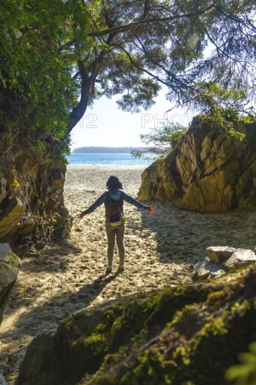 Female tourist with open arms enjoying breathtaking view of mackenzie beach after hiking through