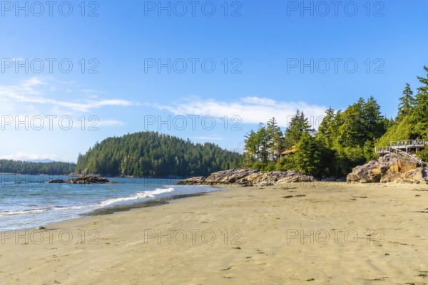 Golden sands meet crystal clear waters under a vibrant blue sky, creating a serene paradise at