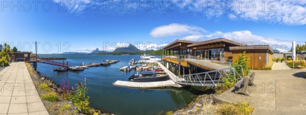 Modern architecture blends seamlessly with the natural beauty of tofino's harbor, featuring boats