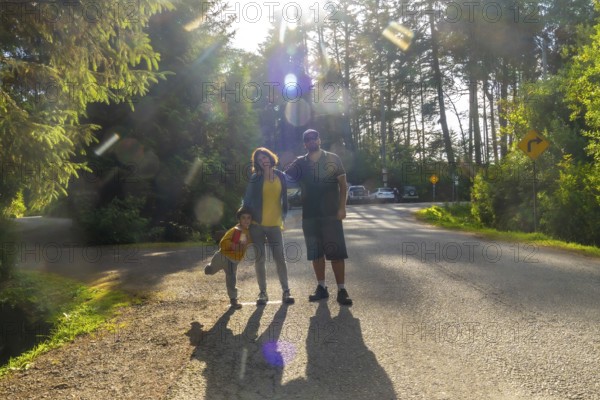 Happy family posing on a sunny day in tofino, vancouver island, british columbia, canada, enjoying