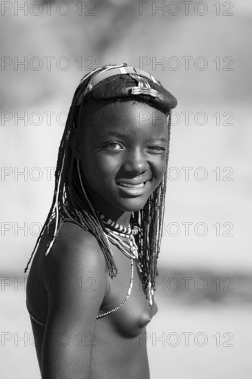 Black and white, portrait, brightly decorated girl winking, Hakaona tribe, also Havakona or