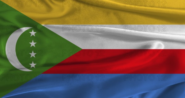 Flag of Comoros with fabric textured background. Close up of National flag of Comoros with