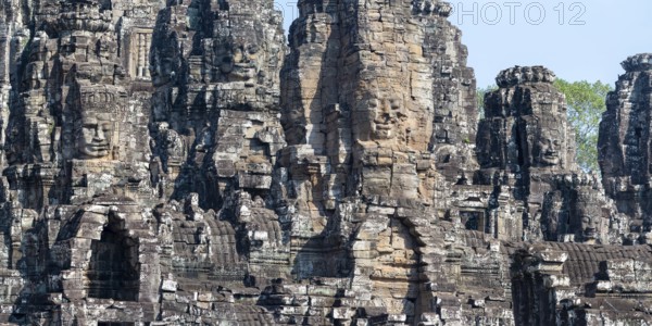 Panoramic picture of huge stone-carved faces of Bodhisattva Lokeshvara, also Avalokiteshvara, Bayon