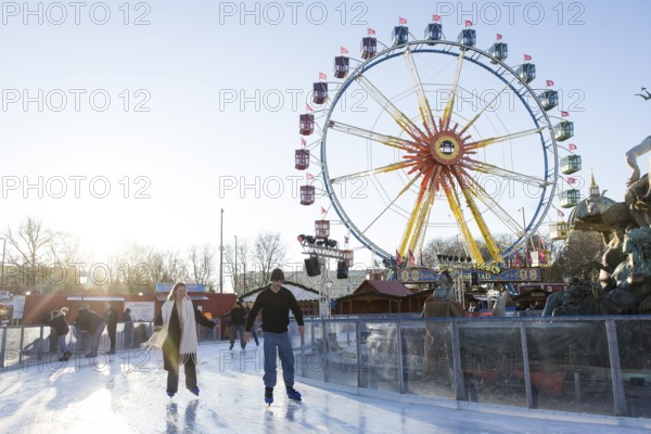 Skaters in front of the Ferris wheel at the Berlin Christmas market on Alexanderplatz, Berlin, 15