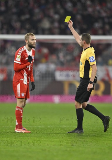 Referee Dr Robin Braun shows Konrad Laimer FC Bayern Munich FCB (27) yellow card yellow caution