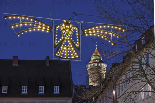 Historic Sinwell Tower illuminated in the evening, Christmas angel glowing in front for Advent, Old