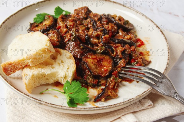 Stewed meat with eggplant is a Georgian dish, on a light background, homemade, no people