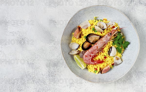 Seafood paella, on a plate, traditional Spanish dish, top view, no people