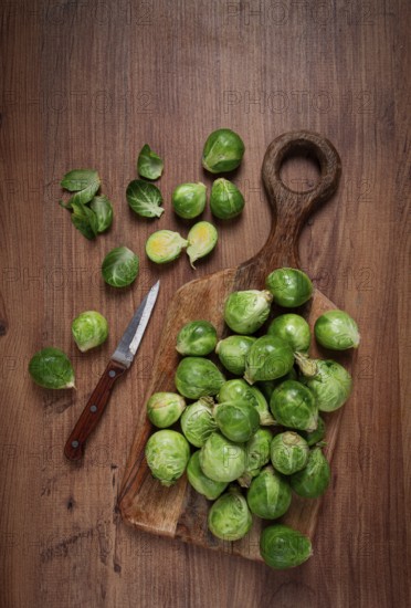 Fresh Brussels sprouts, raw, top view, on a wooden table, no people