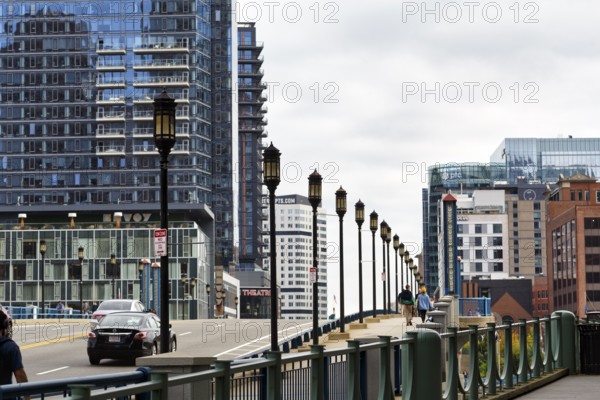 Street lights on Congress Street Bridge, passers-by on pedestrian walkway, office towers, Financial
