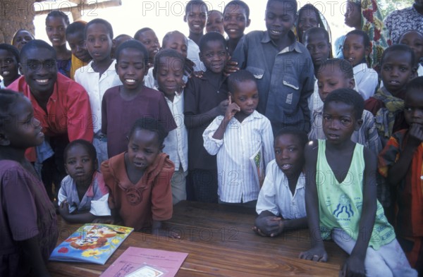 In a World Vision project, friends and neighbors have gathered on the occasion of a godfather's