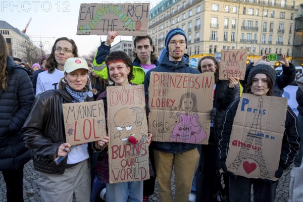 Activists from Fridays For Future holding cardboard signs at Fridays for Future rally on the tenth