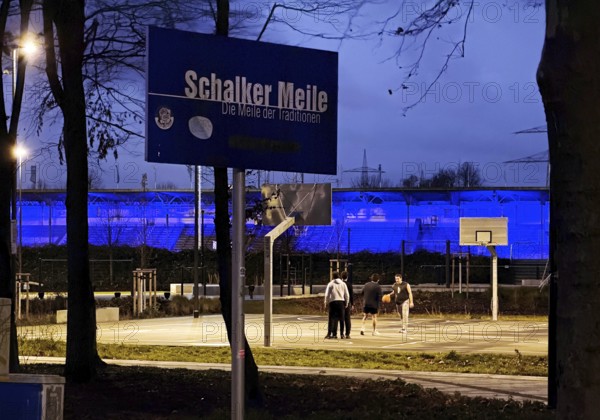 Schalker Meile sign at Ernst-Kuzorra-Platz in front of the royal blue illuminated Glückauf battle