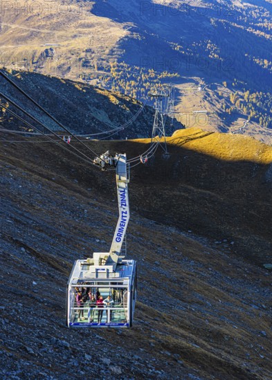 Visitors enjoy the view from the viewing terrace of a gondola from Grimentz to the Espace Weisshorn