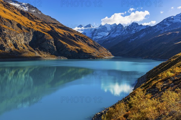 The Lac de Moiry reservoir, with the snow-capped peaks of the Grand Cornier, Tete Blanche and