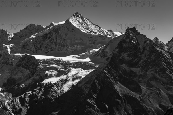 The snow-capped peaks of the Zinalrothorn and Besso mountains, black and white photo, Val