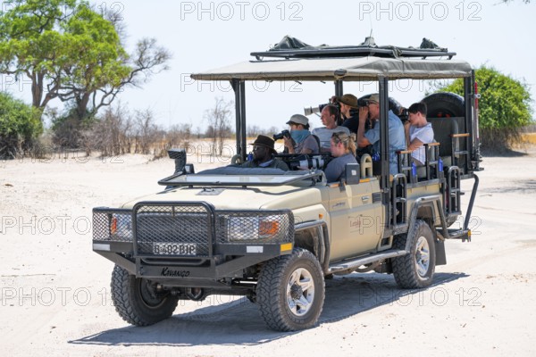 Safari car on safari with tourists in National Park, Savuti, Chobe National Park National Park,