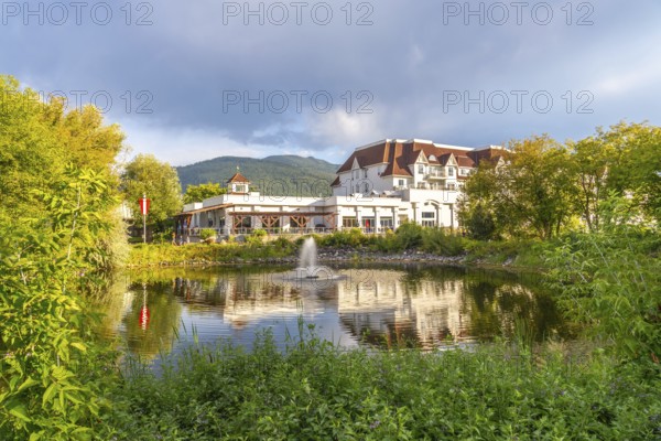 Picturesque salmon arm in british columbia features a luxurious hotel reflected in a serene pond,