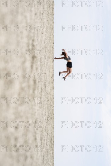 Symbolic picture, abstract, woman falling, rotated image on the Etosha pan, salt pan, Etosha