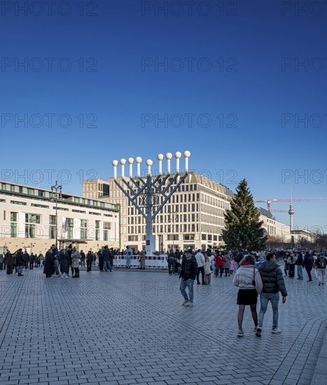 Large Hanukkah chandelier at the Brandenburg Gate in daylight, sign of lively Jewish life, symbolic