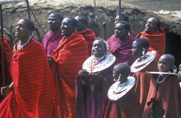 Maasai men and girls in their village in the Ngorongoro Crater dancing for tourists, Tanzania,