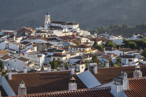 View over village Yunquera, church and typical white houses, mountain range Sierra de las Nieves,
