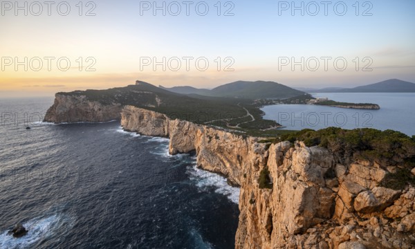 Coastal landscape at sunset, steep cliffs by the sea, cliffs in the evening light, Capo Caccia,