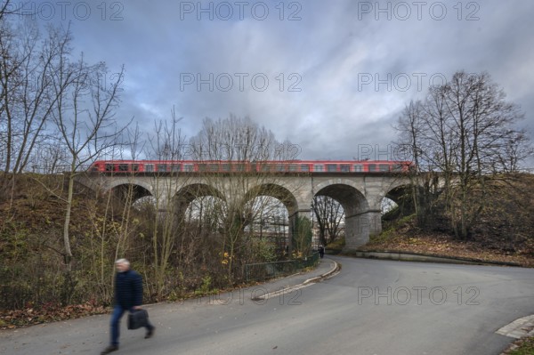 Regional train travels over the historic stone railway viaduct, built in 1876, Lauf an der Pegnitz,