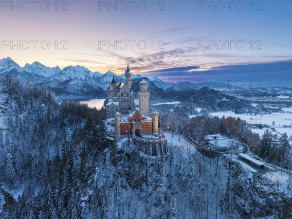 Winter evening with Neuschwanstein Castle and a peaceful landscape of mountains and snow in soft