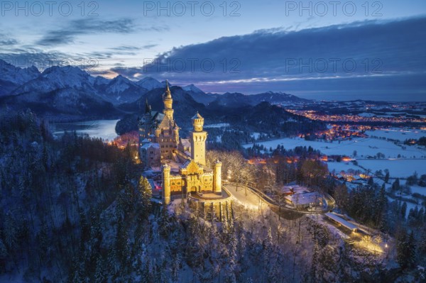 Neuschwanstein Castle illuminated in snowy night landscape, night view, Schwangau near Füssen,