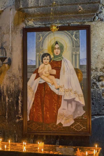 Madonna icon with child in a candle-illuminating church room, Akhtala monastery, Akhtala town,