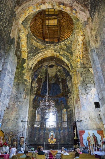 Large church interior with old wall paintings and a richly decorated altar, Akhtala monastery,