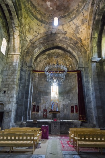 Spacious church room with altar, high ceiling and magnificent chandelier, Sanahin monastery,