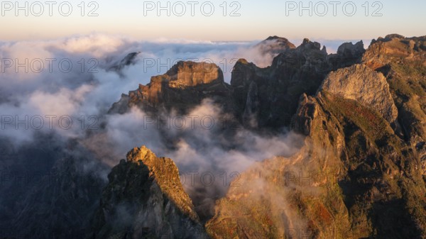 Aerial view, sunrise at Pico do Arieiro, clouds of fog sweeping over mountain peaks, Madeira,