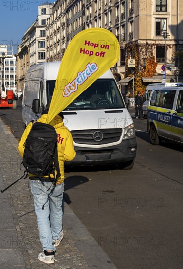 Cityscape, A man carrying the advertising banner of the Hop on Hop off buses from City Circle,