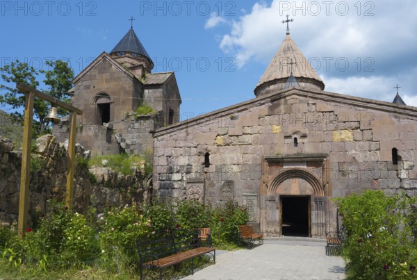 Historic monastery with towers and stone walls, surrounded by garden, Goshavank monastery, Tavush
