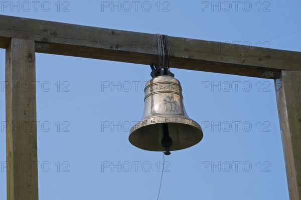 Metal bell on a wooden structure against a clear blue sky, Goshavank monastery, Tavush province,