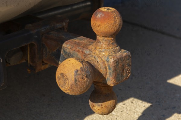 Close-up of rusted tri-ball trailer hitch attached to sport utility vehicle, Quebec, Canada