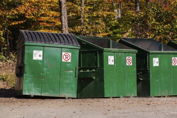 Green painted metal with black plastic lid industrial size waste bins for depositing garbage and