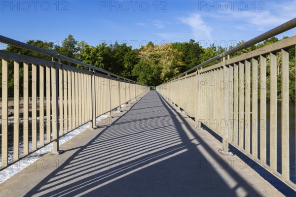 Wide angle view of pedestrian walkway on top of water flow control Moulin Neuf dam over Des