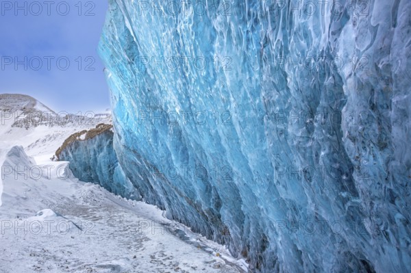 Glacier wall showing smooth melting blue ice made of compressed snow, Spitsbergen / Svalbard,