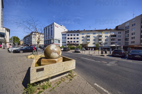 Stone fountain, sidewalk, concrete paving stones, general architecture, houses, residential and