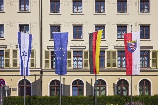 Flags, Israeli flag, European flag, German flag, flag of Hesse, flagpoles, façade with windows and